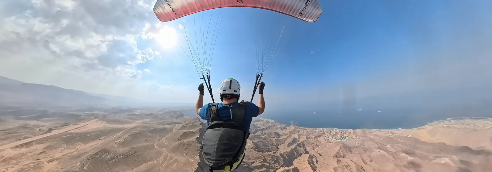 Pilot paragliding above the Egyptian coastline